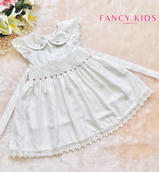 Hand smocked hand embroidered white dress with bead work